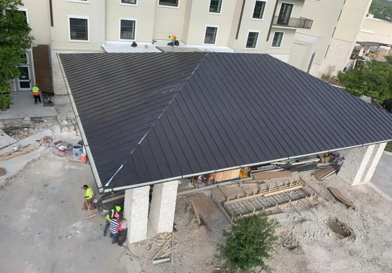 Metal roofing installation team working on a commercial building in Hackensack
